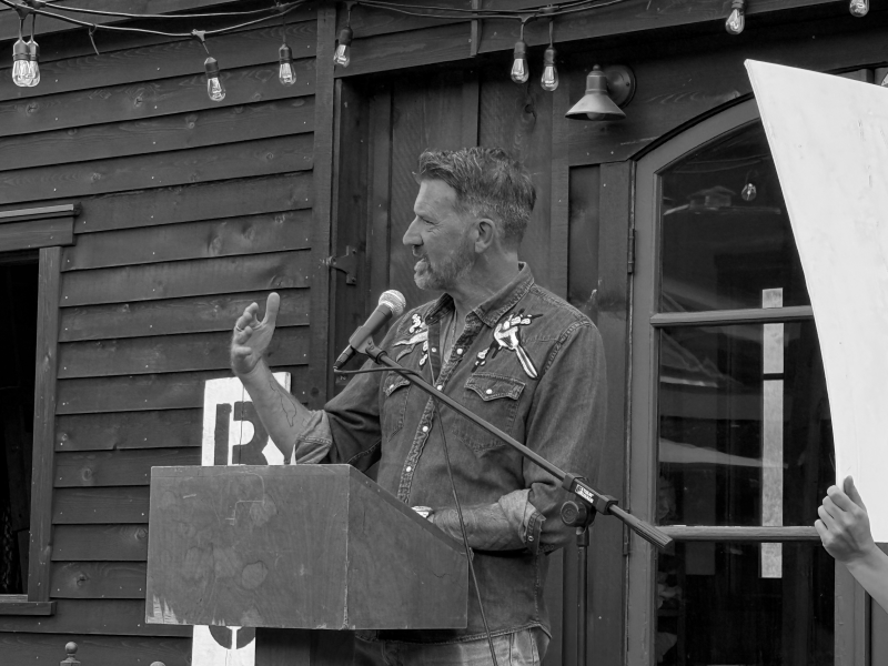 Author and Borchard Foundation Director Michael Spurgeon reads from the tiny house deck at the 2026 Writers Workshops of the Community of Writers
