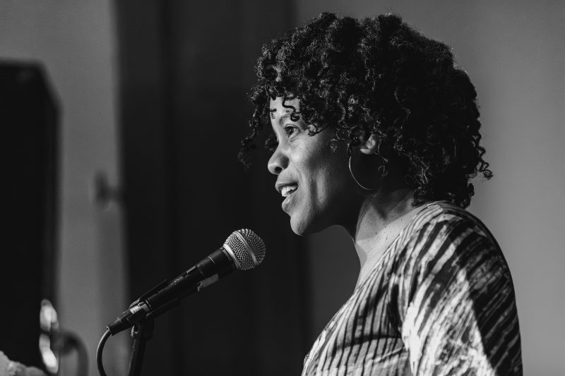 Poet Ama Codjoe reads from the stage at the 2026 Poetry Benefit Reading of the Community of Writers Poetry Program. Photo by Nic Nichols nicholasnichols.com @maruneboy